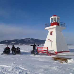motoneigistes au phare de Carleton en Gaspésie